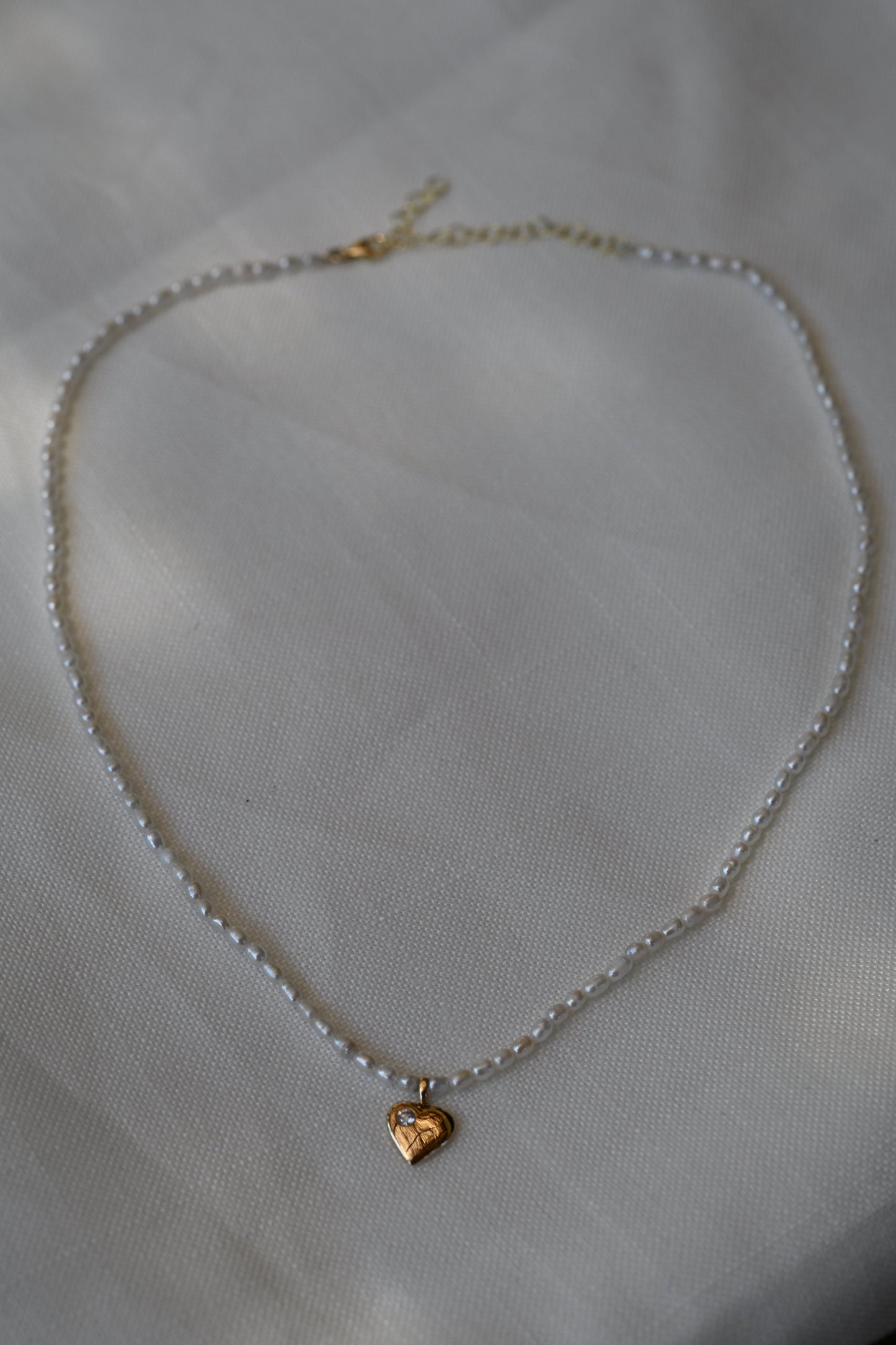 Dalia T Online Timeless 'rice' Pearl necklace with a heart & a Diamond